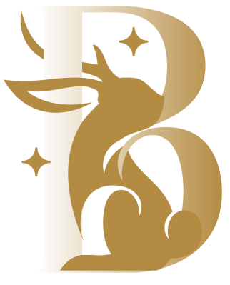 A logo featuring a jackalope wrapped in a letter "B" in gold hues with stars to symbolize Brittany's design business